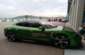 green color porsche hybrid charging on station
