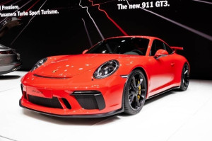 Red Porsche 911 GT3 sports car displayed at an auto show.