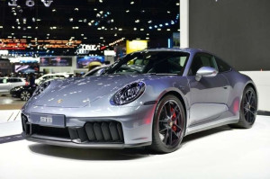 Silver Porsche 911 sports car showcased at an auto exhibition.