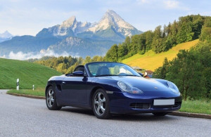Blue roadster Porsche Boxster 986 with mountain Watzmann