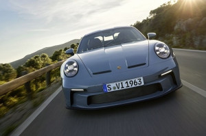 Man is driving Porsche 911 fast on the road 
